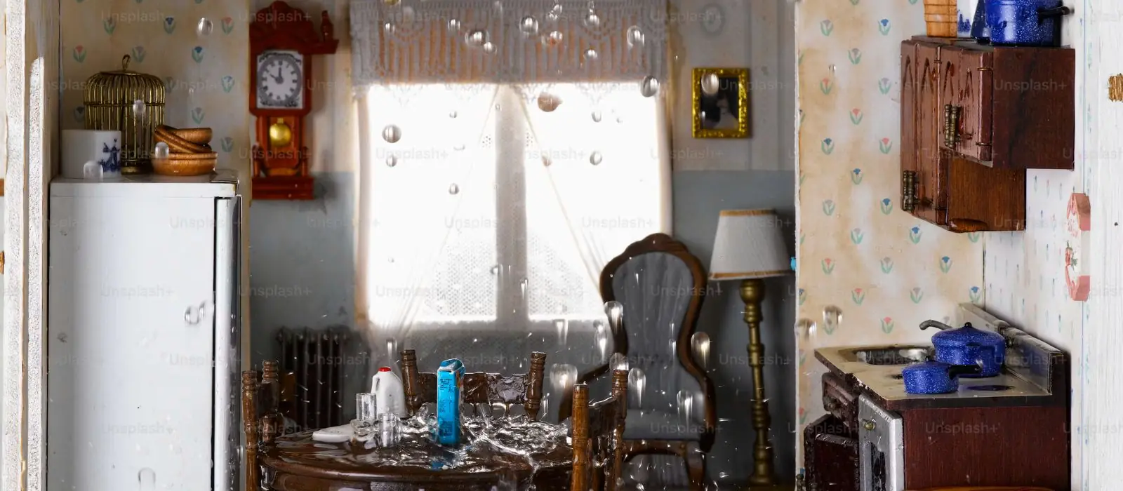 Older home interior with a vintage kitchen, a wall clock and water droplets falling through the room